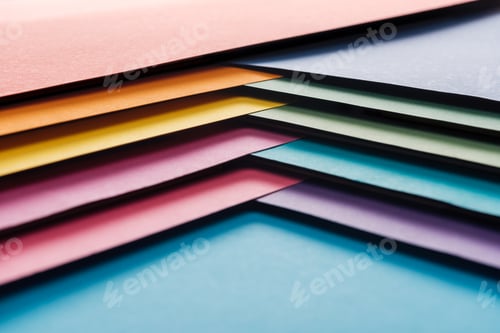 Preview: blank and bright blue, orange, green, yellow, pink and purple sheets of paper on blue background