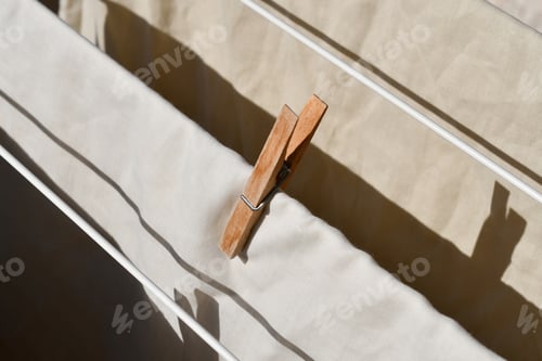 Preview: Clothes pegs or pins with clothes on drying rack.