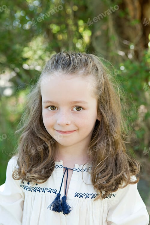 Preview: Young girl with a gentle smile standing in a sunlit garden