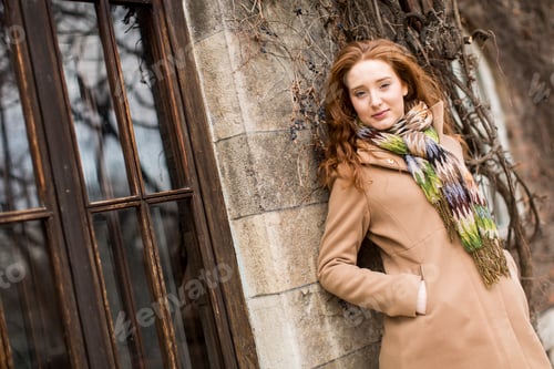 Preview: Young woman by the wall