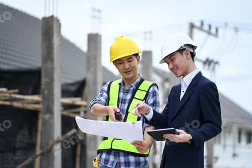 Preview: Engineer and businessman planning development details about project at construction site