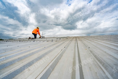 Preview: technician lifting a photovoltaic panel during installation