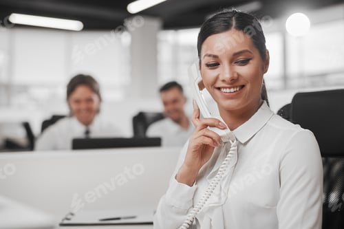 Preview: Ethnic secretary speaking on phone in office
