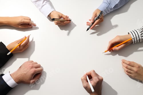 Preview: Human hands with pens on a light background
