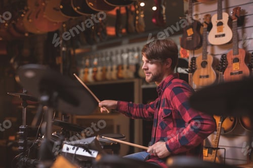 Preview: Man Plays Electronic Drums in a Music Store