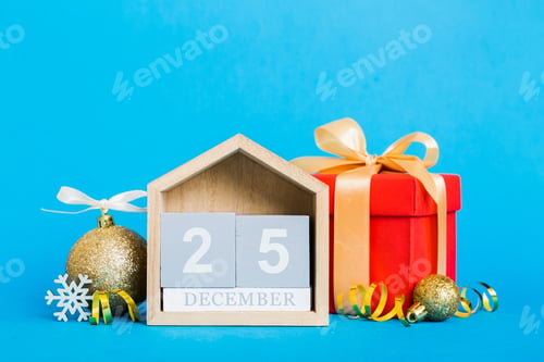Preview: 25 december. Christmas composition on colored background with a wooden calendar