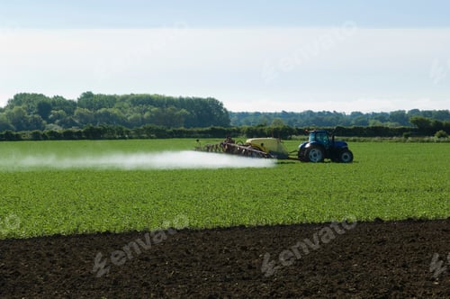 Preview: Tractor and crop sprayer spraying in field