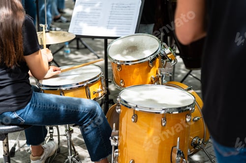 Preview: Female musician percussionist playing drums