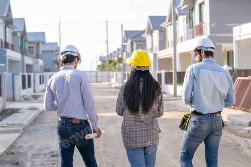 Preview: Architect and engineer discussing planning for a building a new home at construction site.