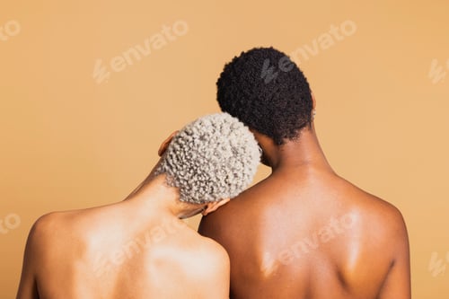 Preview: Rear view of two african american women on brown background.