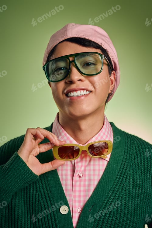 Preview: Stylish man showcases vibrant fashion against a green backdrop in modern studio setting