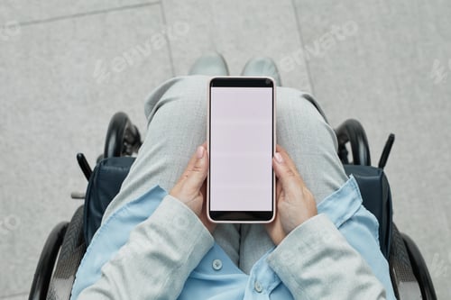 Preview: Woman in Wheelchair Using Smartphone Closeup