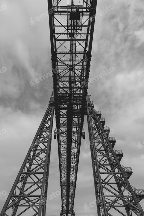 Preview: Steel bridge structure against cloudy sky.