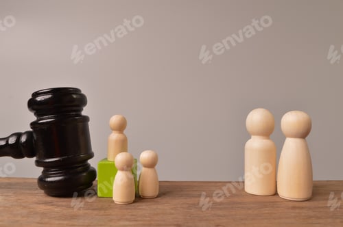 Preview: Wooden doll figures and judge gavel. The concept, of children protection from the criminal offence