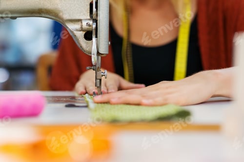 Preview: Hands of unrecognizable tailor woman working with sewing machine