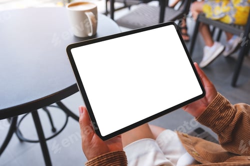 Preview: Mockup image of a woman holding digital tablet with blank white desktop screen in cafe