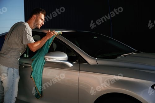Preview: Working, polishing the automobile. Man is with his car outdoors