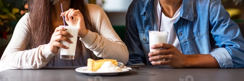 Preview: Two mixed race teens drinking milkshakes, eating cheesecake