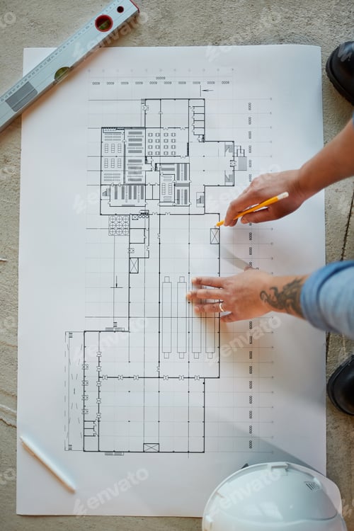 Preview: Female Worker Looking at Plans Top View