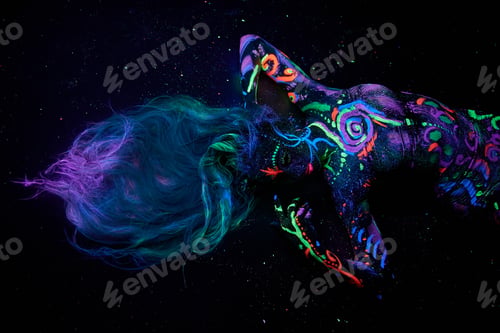 Preview: Art woman hair in ultraviolet light. Bright abstract drawings girl body neon color. Fashion