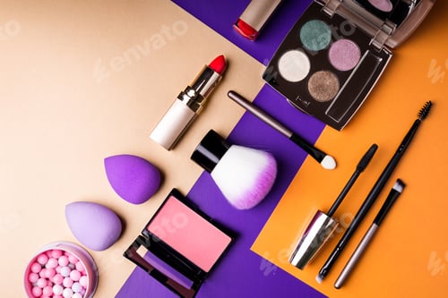 Preview: Makeup products and decorative cosmetics on color background flat lay. Fashion and beauty
