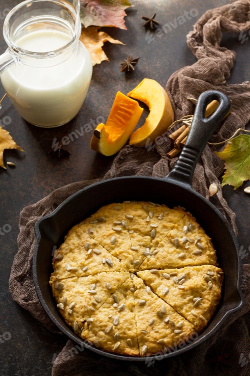 Preview: Traditional English cuisine. Breakfast table with pumpkin scones and milk.