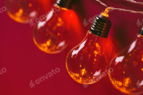 Preview: Beautiful illuminated festive light bulbs garland close up
