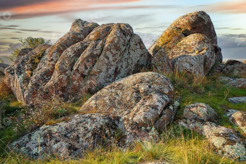 Preview: A small pile of stones in a green-yellow field against the background of a sky in Ukraine
