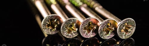 Preview: panoramic shot of heads of metal studs isolated on black