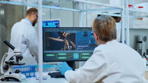 Preview: Medical research scientist typing codes on computer