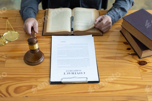Preview: Lawyer reading a book and working in a law firm, Legal counsel and justice concept.