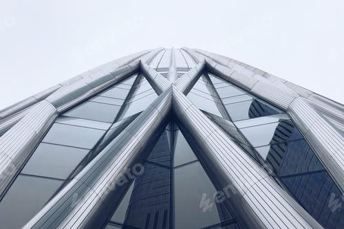 Preview: Low angle shot of an amazing architecture reflecting other buildings around it through the windows