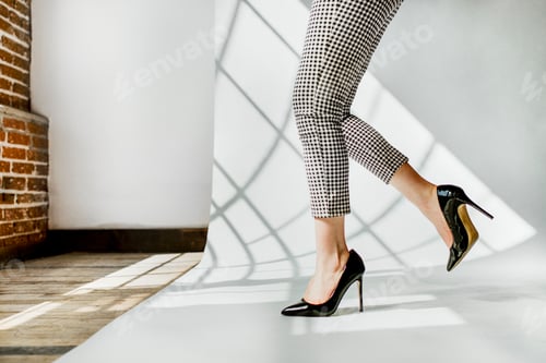 Preview: Woman Wearing Checkered Pants and High Heels