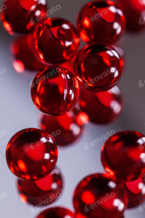 Preview: red capsules on mirror background