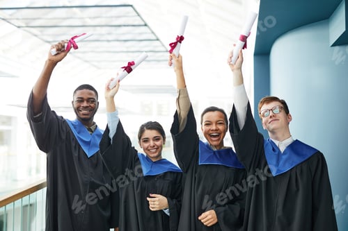 Preview: University graduates holding dplomas indoors
