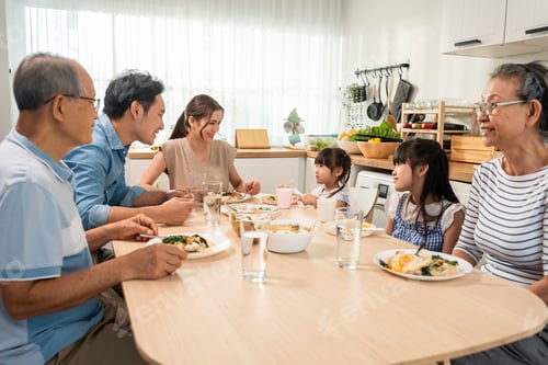 Preview: Asian big happy family have lunch on eating table together in house.