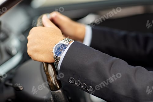 Preview: senior businessman hands driving car