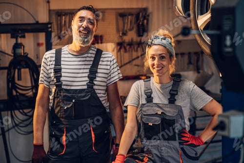 Preview: Portrait of professional colleagues technicians at auto mechanic shop.