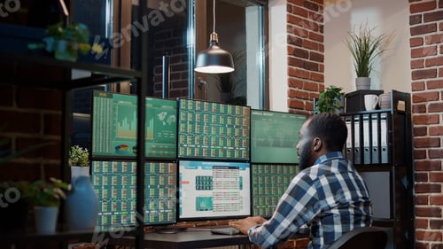 Preview: Male financial analyst looking at real time stocks exchange