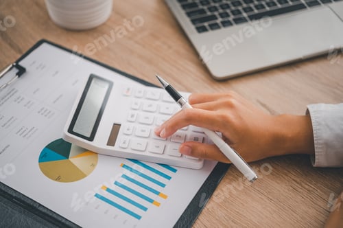 Preview: close up The business person is sitting on a calculator with a graph