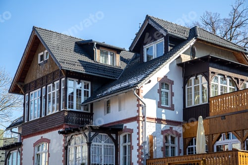 Preview: A beautiful textured house with wooden inserts and many add-ons.