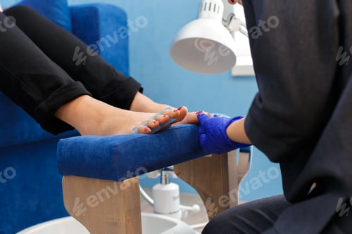 Preview: Foot care service being provided in a beauty salon with focus on nails and relaxation