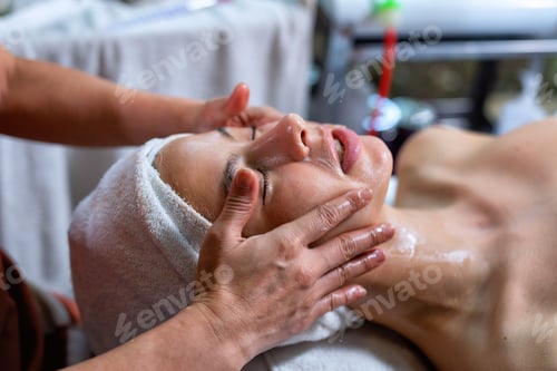 Preview: Beautiful young woman lying down on massage beds at luxury massage and spa and wellness center