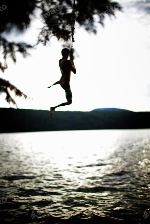Preview: Boy jumping off rope swing