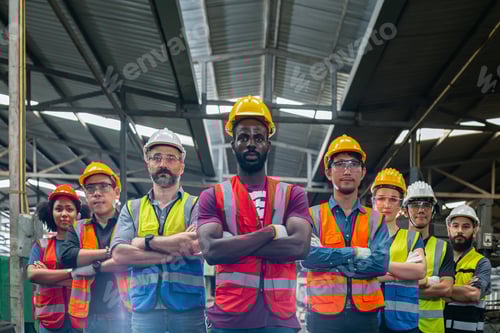 Preview: Various nationalities engineer professional successful team corporate workers standing in factory.