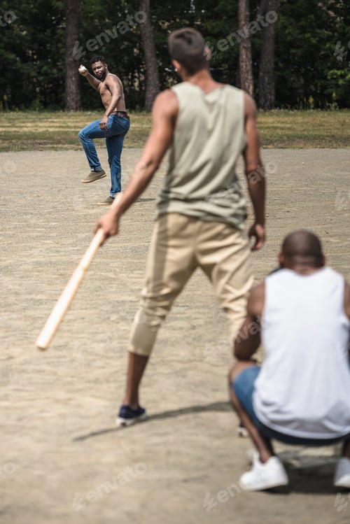 Preview: group of young multiethnic men playing baseball on court
