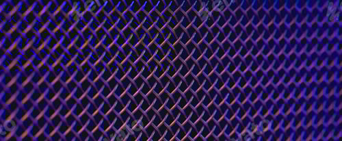 Preview: Metal grill close-up, texture of a music speaker in colored lighting.