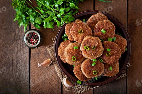 Preview: Juicy delicious meat cutlets on a wooden table in a rustic style.