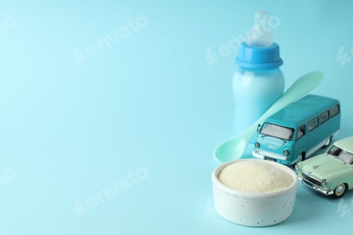 Preview: Concept of baby food with рowdered milk on blue background