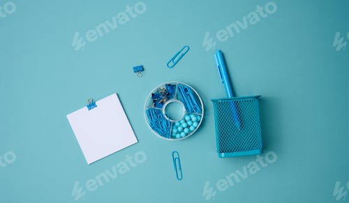 Preview: Stack of white square sheets of paper for notes, stationery on blue background, top view